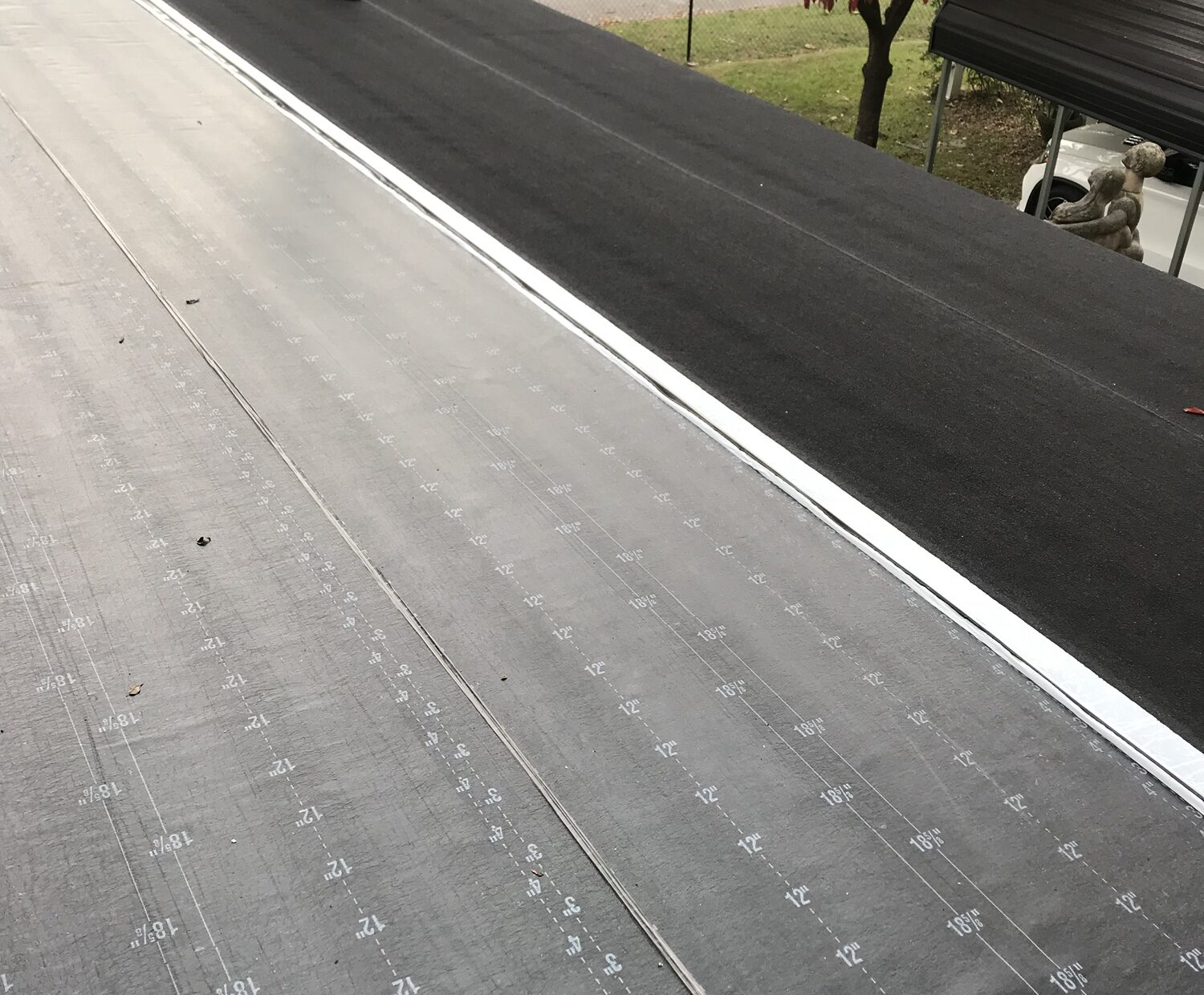 black colored 2-ply flat rolled roofing system