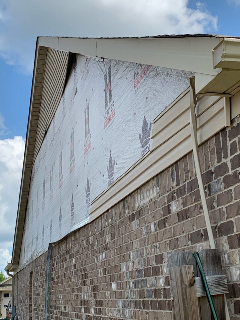 Siding repair in Huntsville: old siding removed showing weatherproof house wrap