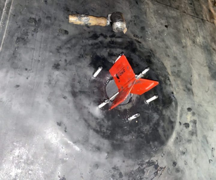Close-up of a retrofit EPDM drain installation on a commercial roof.