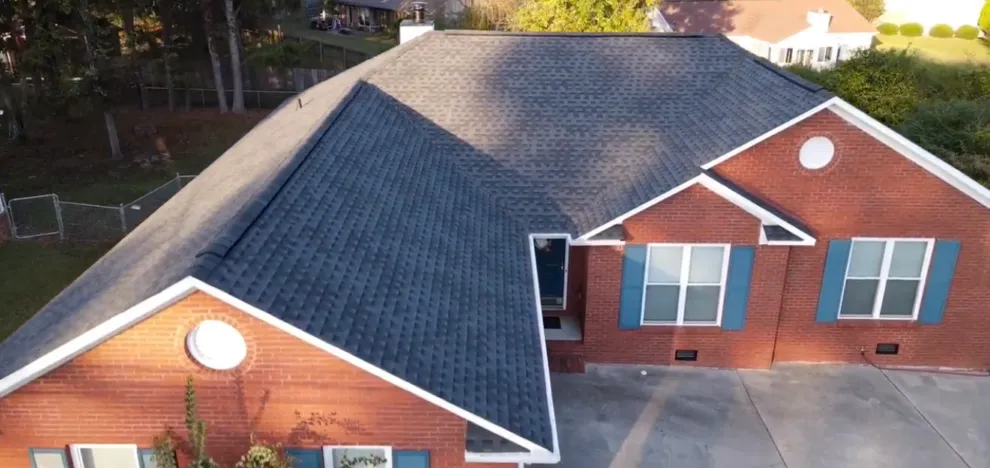 Charcoal dimensional shingle roof on a brick home