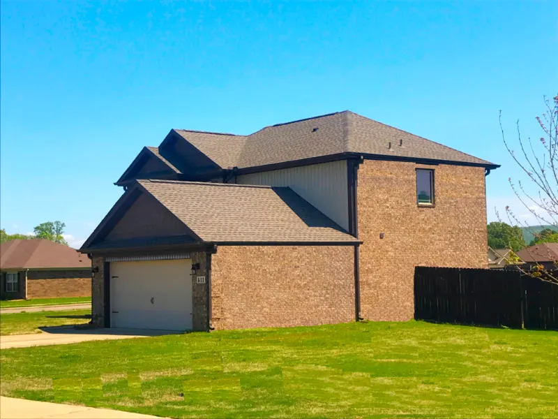 Two-story brick home with a new shingle roof in Owens Cross Roads, Alabama