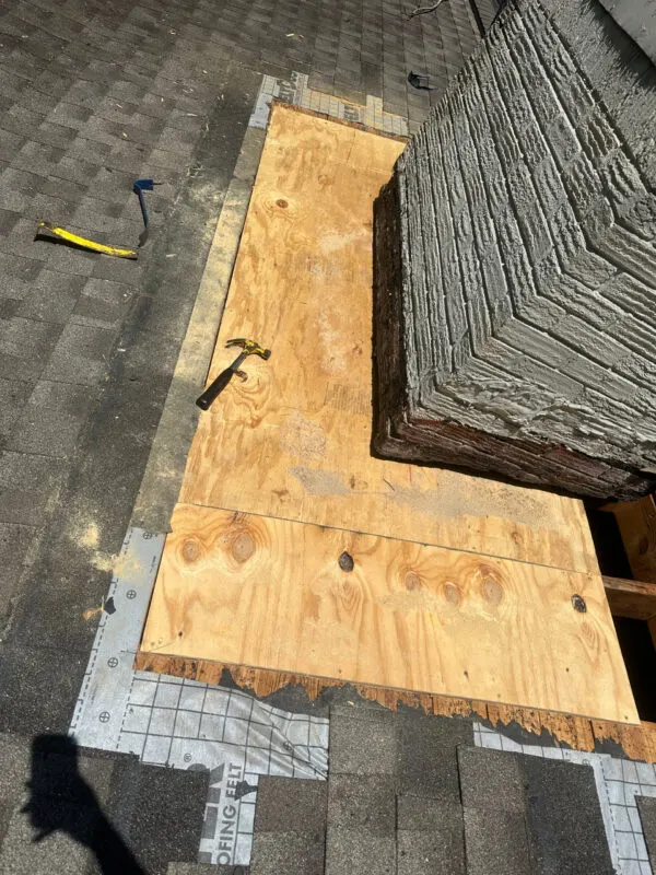 New plywood roof decking being installed before new shingles